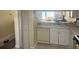 White kitchen with sink, dishwasher, and pass-through at 129 Caryl Way # 129, Oldsmar, FL 34677