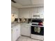 Efficient kitchen featuring white cabinetry and electric range at 129 Caryl Way # 129, Oldsmar, FL 34677