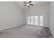 Main bedroom with carpet and access to backyard patio at 13012 Creek Manor Ct, Riverview, FL 33569