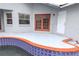 Poolside patio with terracotta tile and access to the pool and house at 13012 Creek Manor Ct, Riverview, FL 33569