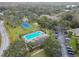 Community overview showing pool, tennis court, and buildings at 13215 Slash Pine Dr # H, Hudson, FL 34669