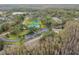 Community aerial view, showing homes, pool, and tennis court at 13215 Slash Pine Dr # H, Hudson, FL 34669
