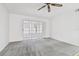 Bedroom with gray carpet and sliding glass doors to balcony at 13215 Slash Pine Dr # H, Hudson, FL 34669