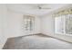 Bright bedroom with neutral carpeting and two windows at 13215 Slash Pine Dr # H, Hudson, FL 34669