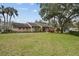 Community building with grassy lawn and landscaping at 13215 Slash Pine Dr # H, Hudson, FL 34669