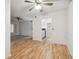 Open dining area with wood floors and kitchen access at 13215 Slash Pine Dr # H, Hudson, FL 34669