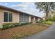 Tan building exterior with landscaping and a paved pathway at 13215 Slash Pine Dr # H, Hudson, FL 34669
