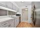 Kitchen with light gray cabinets and stainless steel appliances at 13215 Slash Pine Dr # H, Hudson, FL 34669