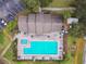 Community pool with lounge chairs and surrounding patio at 13215 Slash Pine Dr # H, Hudson, FL 34669