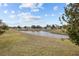 Serene pond view with lush landscaping at 13627 Crest Lake Dr, Hudson, FL 34669