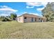 Side view of a single Gathering house with a large backyard at 13717 Pimberton Dr, Hudson, FL 34669