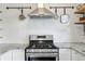 Gas range, granite countertops, and stylish backsplash in this kitchen at 1402 E Mohawk Ave, Tampa, FL 33604