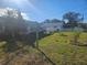 Backyard view with a wooden sign and landscaping at 1468 Flora Rd, Clearwater, FL 33755