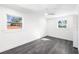 Simple bedroom with grey flooring and two windows at 177 Dowling Ne Ave, Port Charlotte, FL 33952