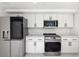 Modern kitchen with stainless steel appliances and white cabinets at 177 Dowling Ne Ave, Port Charlotte, FL 33952