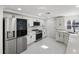 Modern kitchen with white cabinets, quartz countertops, and stainless steel appliances at 177 Dowling Ne Ave, Port Charlotte, FL 33952