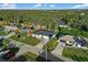 Aerial view of three houses on a tree-lined street at 18434 Goodman Cir, Port Charlotte, FL 33948