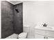 Modern bathroom with dark gray tile shower and white vanity at 18434 Goodman Cir, Port Charlotte, FL 33948