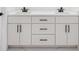 Bathroom featuring a double vanity with white cabinets and black hardware at 18434 Goodman Cir, Port Charlotte, FL 33948