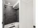 Modern bathroom with dark gray tile shower and white vanity at 18434 Goodman Cir, Port Charlotte, FL 33948