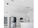 Modern kitchen featuring white shaker cabinets, stainless steel appliances, and a large island at 18434 Goodman Cir, Port Charlotte, FL 33948
