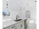 Modern kitchen with white cabinets, quartz countertops, and a large island at 18434 Goodman Cir, Port Charlotte, FL 33948