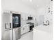 Modern kitchen with stainless steel appliances and white shaker cabinets at 18434 Goodman Cir, Port Charlotte, FL 33948
