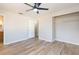 Bedroom with ceiling fan, wood-look floors and double door closet at 1905 Bryan Rd, Brandon, FL 33511