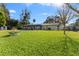 Large backyard with grassy lawn and pool view at 1985 Byram Dr, Clearwater, FL 33755