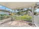 Relaxing covered porch with white railing overlooks a green lawn at 1985 Byram Dr, Clearwater, FL 33755