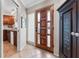 Bright entryway with a view into the kitchen and a unique wooden door at 1985 Byram Dr, Clearwater, FL 33755