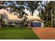 Charming ranch home with a spacious yard and updated blue garage door at 1985 Byram Dr, Clearwater, FL 33755