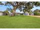 Large oak tree shades the front yard of this beautiful home at 1985 Byram Dr, Clearwater, FL 33755