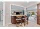 Kitchen breakfast bar with seating for two, granite countertop, and dark wood cabinets at 1985 Byram Dr, Clearwater, FL 33755