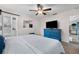 Main bedroom with TV, blue dresser, and access to bathroom at 1985 Byram Dr, Clearwater, FL 33755