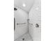 Accessible shower with grab bars and white tile at 1985 Byram Dr, Clearwater, FL 33755