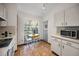 Bright eat-in kitchen with white cabinets and tile floors at 2058 Villa Ter, Clearwater, FL 33763