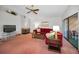 Living room features a red sectional sofa, fireplace, and access to a patio at 2058 Villa Ter, Clearwater, FL 33763