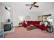 Living room featuring red sectional sofa, coffee table, and fireplace at 2058 Villa Ter, Clearwater, FL 33763