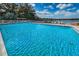 Community pool with lake view and lounge chairs at 2058 Villa Ter, Clearwater, FL 33763