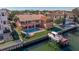 Aerial view of two-story house with pool and canal access at 207 8Th E St, Tierra Verde, FL 33715