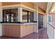 Outdoor wet bar with tiled floor and sliding glass doors at 207 8Th E St, Tierra Verde, FL 33715