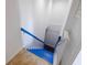 Indoor blue painted stairs leading down to the lower level at 207 8Th E St, Tierra Verde, FL 33715