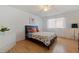 Bedroom with a full-size bed, dresser, and hardwood floors at 207 8Th E St, Tierra Verde, FL 33715