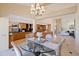 Bright dining area with glass table and chandelier, adjacent to kitchen at 207 8Th E St, Tierra Verde, FL 33715