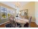 Elegant dining room with a wooden table and chairs, and a decorative chandelier at 207 8Th E St, Tierra Verde, FL 33715