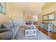 Spacious living room with hardwood floors, a large sofa, and a view to the dining room at 207 8Th E St, Tierra Verde, FL 33715