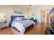 Main bedroom with plush bed and wood flooring at 207 8Th E St, Tierra Verde, FL 33715