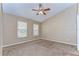 Spacious bedroom with neutral walls, ceiling fan, and two windows at 2131 Golden Oak Ln, Valrico, FL 33594