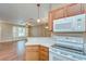 Kitchen with oak cabinets, white appliances and view to living room at 2131 Golden Oak Ln, Valrico, FL 33594